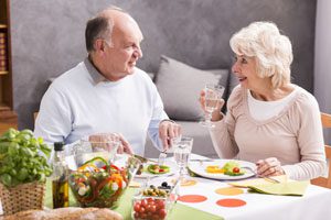 elderly couple talking over brunch in restaurant