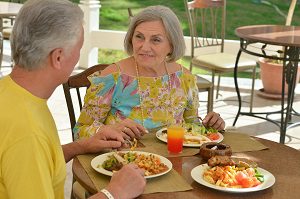 wife eating dinner at home with her husband