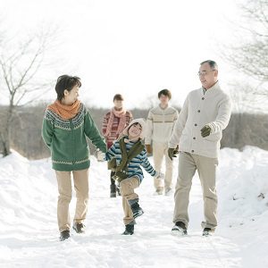 family playing in snow after storm