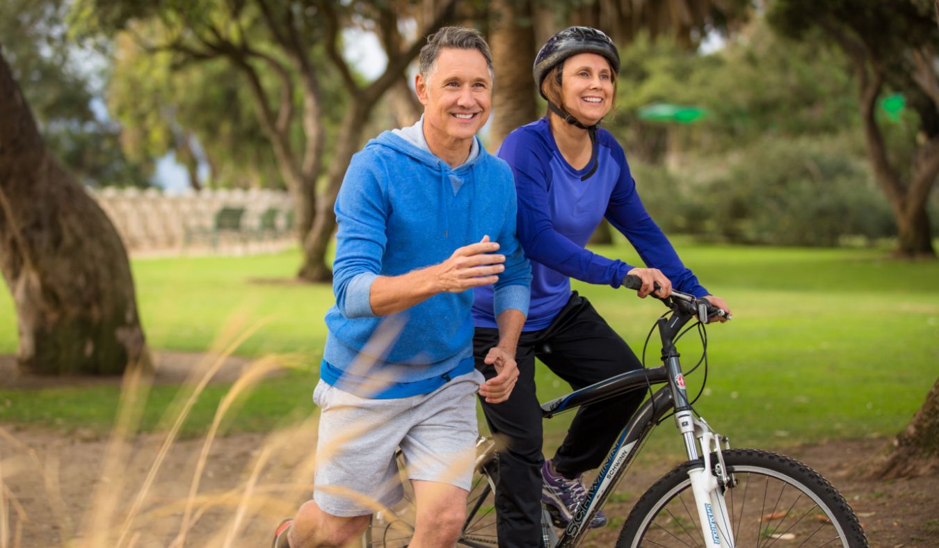 older couple running biking
