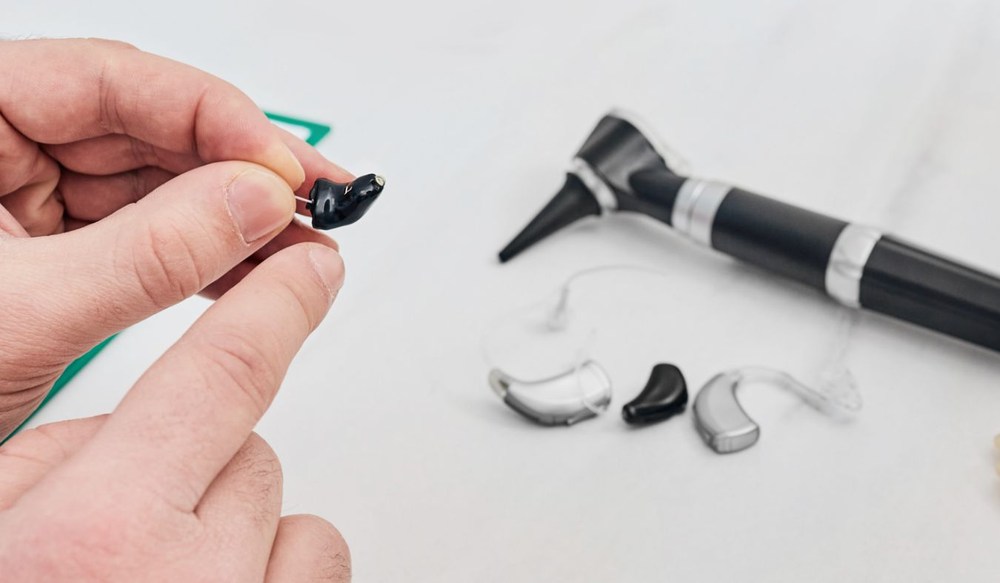 hearing aid in hand consultation with options