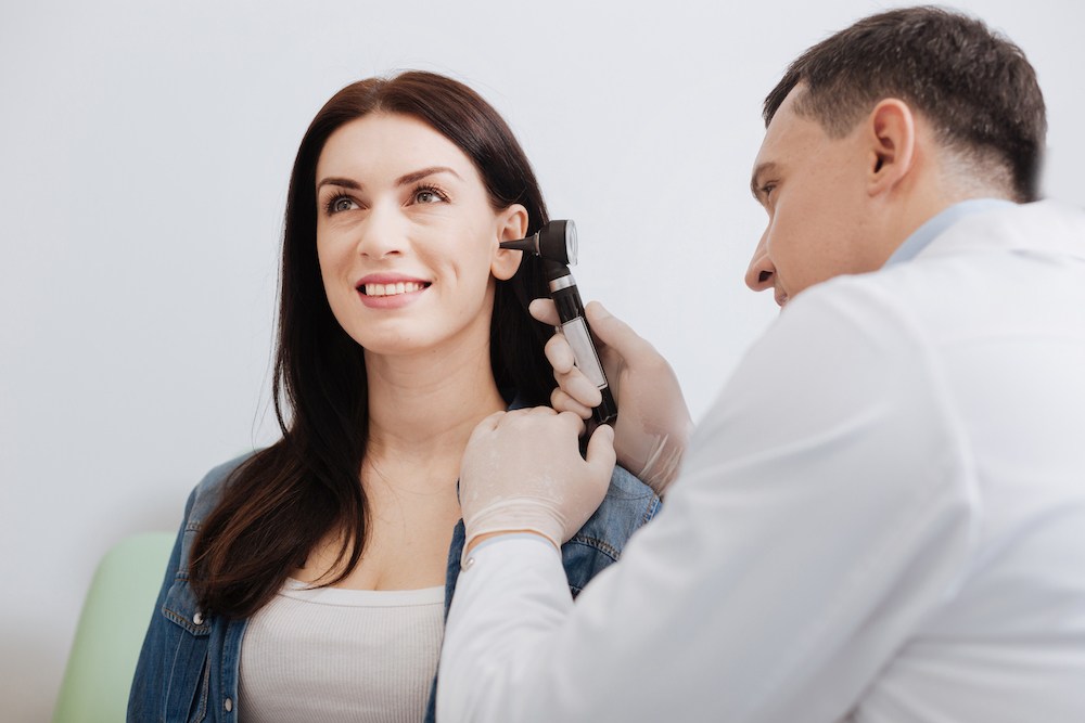 woman smiling at her professional hearing examination