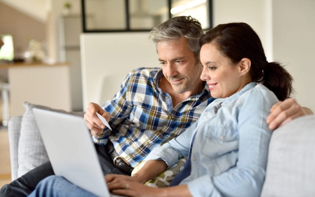 a couple looking at hearing aids on the internet