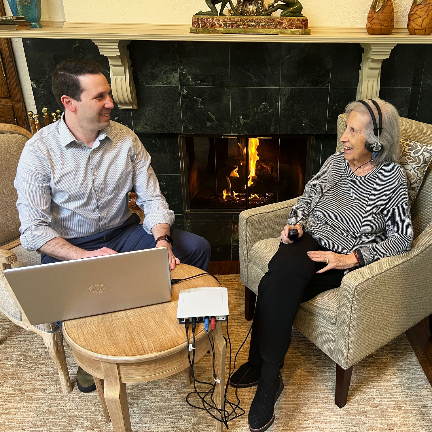 Dr Craig Heffron performing hearing test with patient at home