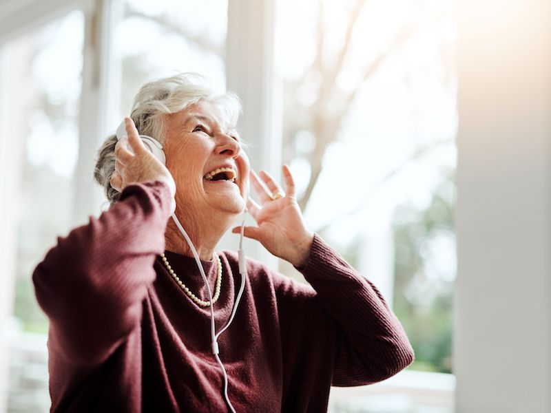old woman enjoying music