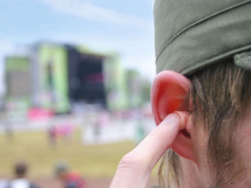 a pair of custom earplugs worn by man
