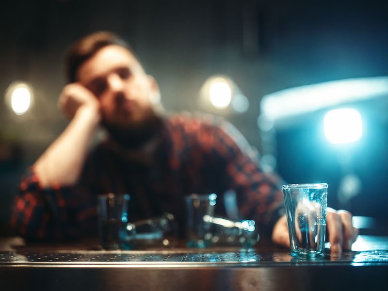 man with hand on head in shame of his substance abuse