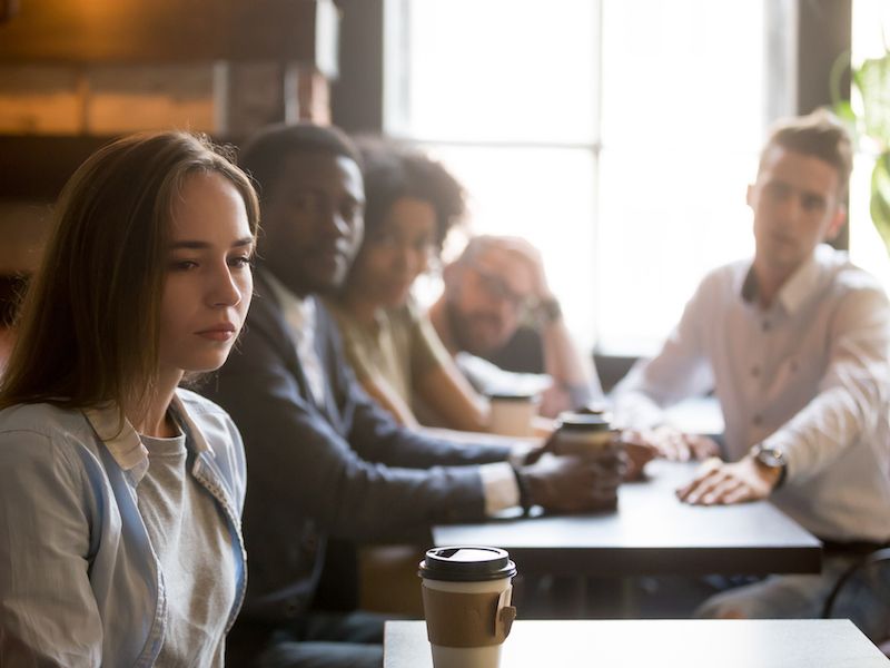 group of young people sitting at a table