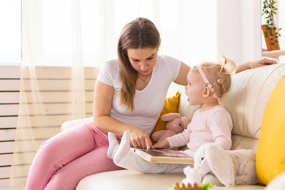 woman speaking with her child about hearing loss