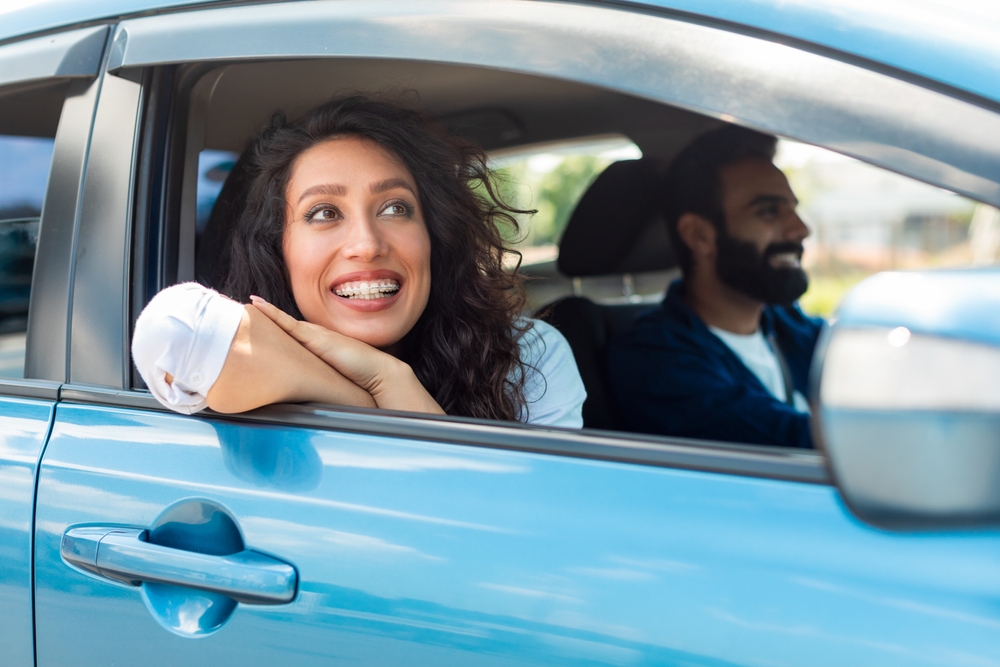 Smiling,Dreamy,Arab,Lady,Riding,In,Car,Looking,Out,The