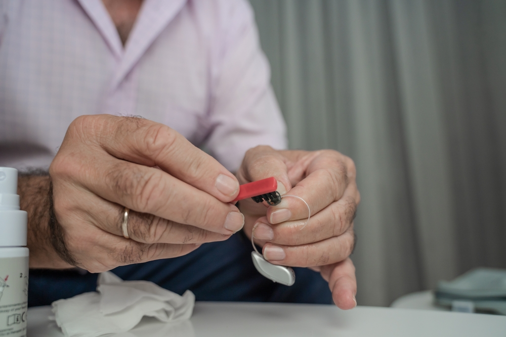 Grandfather,Cleaning,His,Hearing,Aids,So,He,Can,Listen