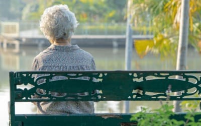 Woman sitting on bench alone 400x250