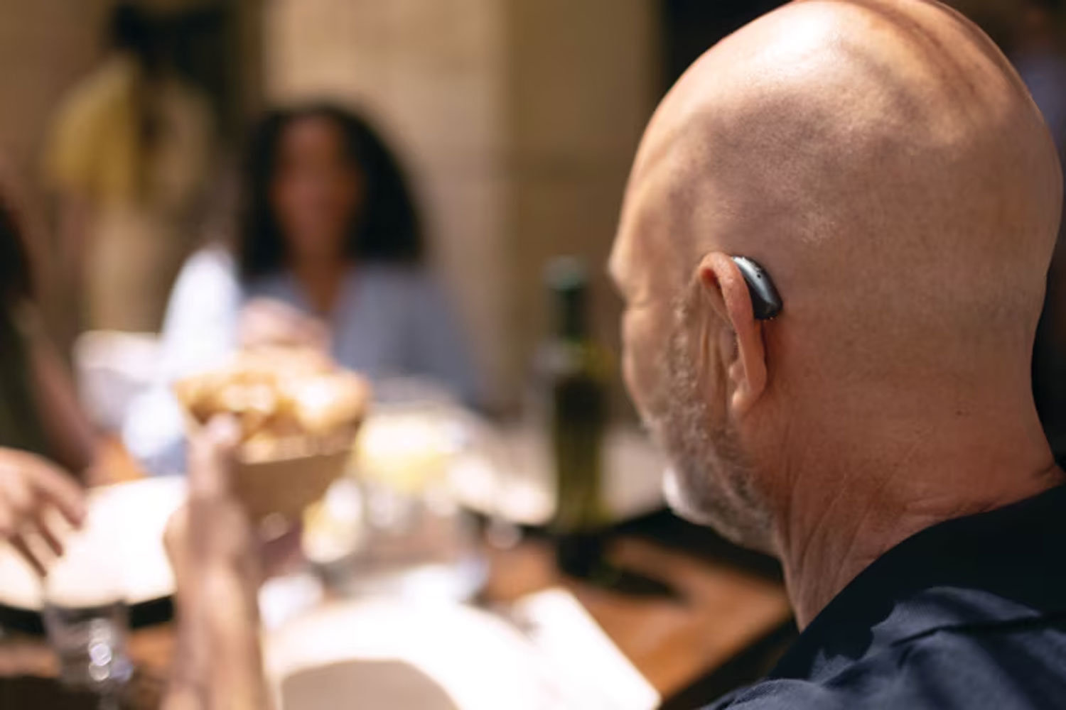 phonak audeo sphere infinio lifestyle man wearing hearing aid at table