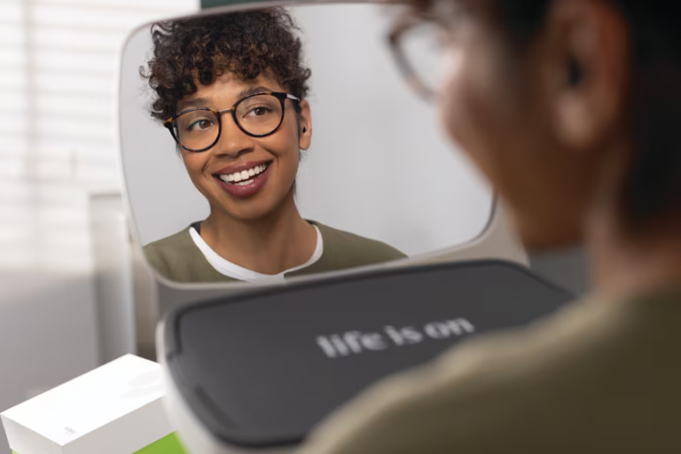 phonak virto infinio lifestyle woman hearing aid fitting mirror