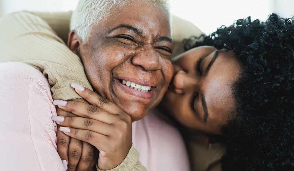 daughter hugging senior mother