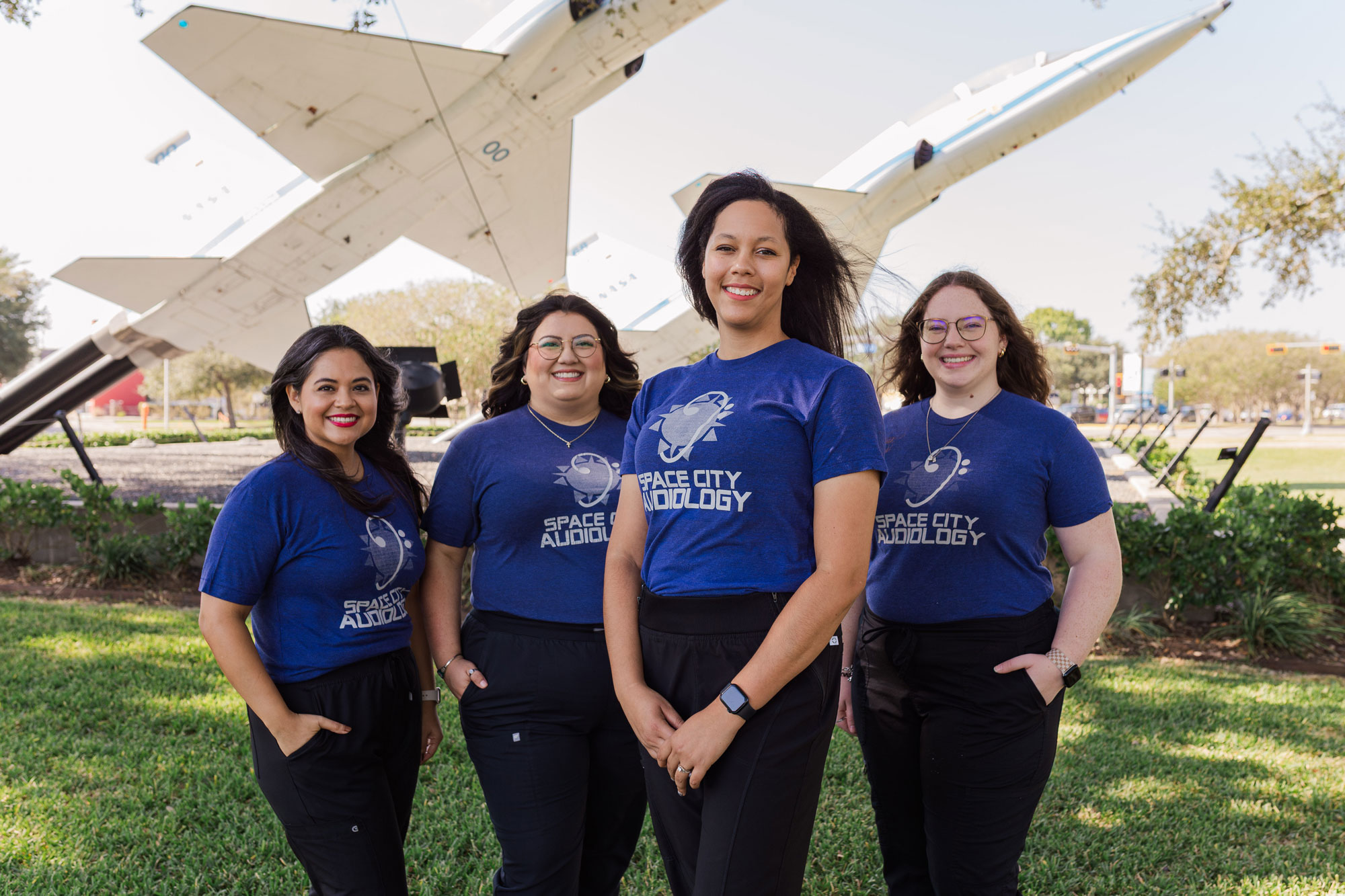 Space City Audiology 124 staff standing in front of planes