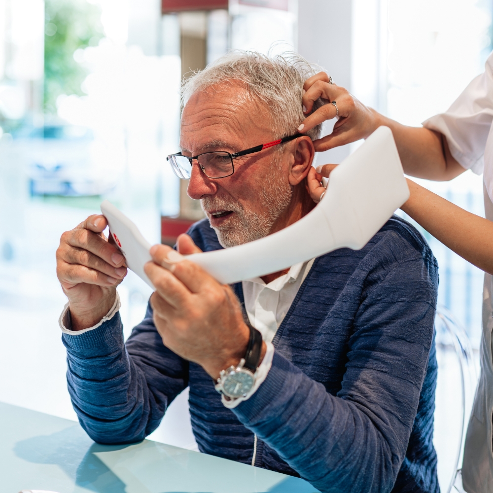man trying on hearing aids