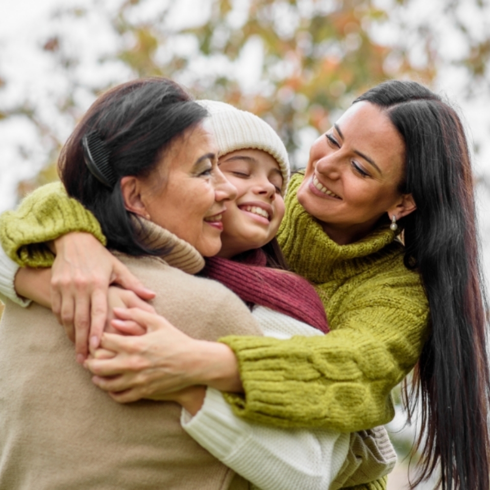 three generations women family hugging