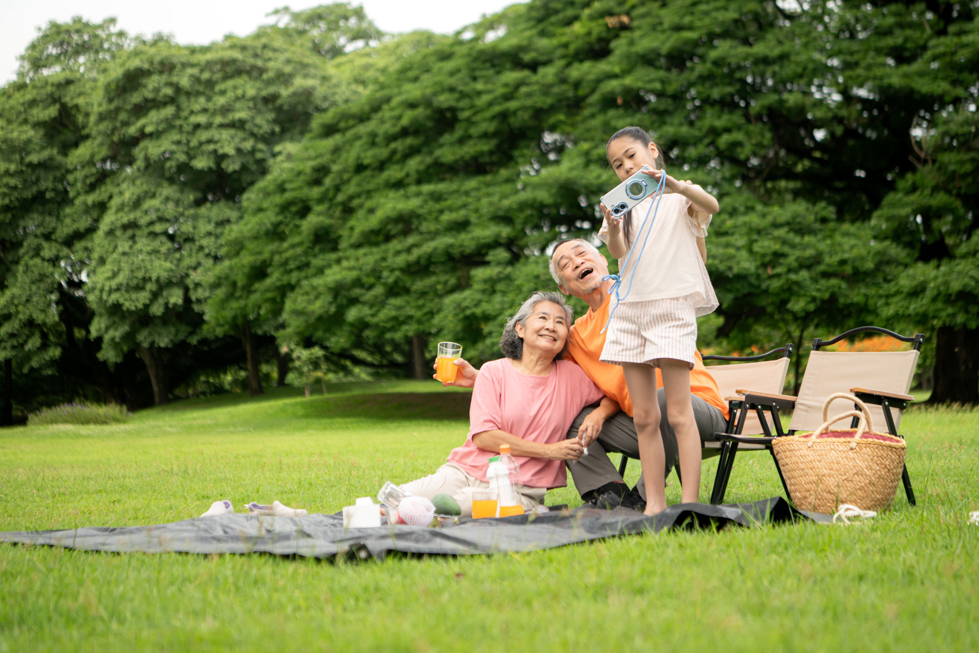 grandparents having picnic with granddaughter