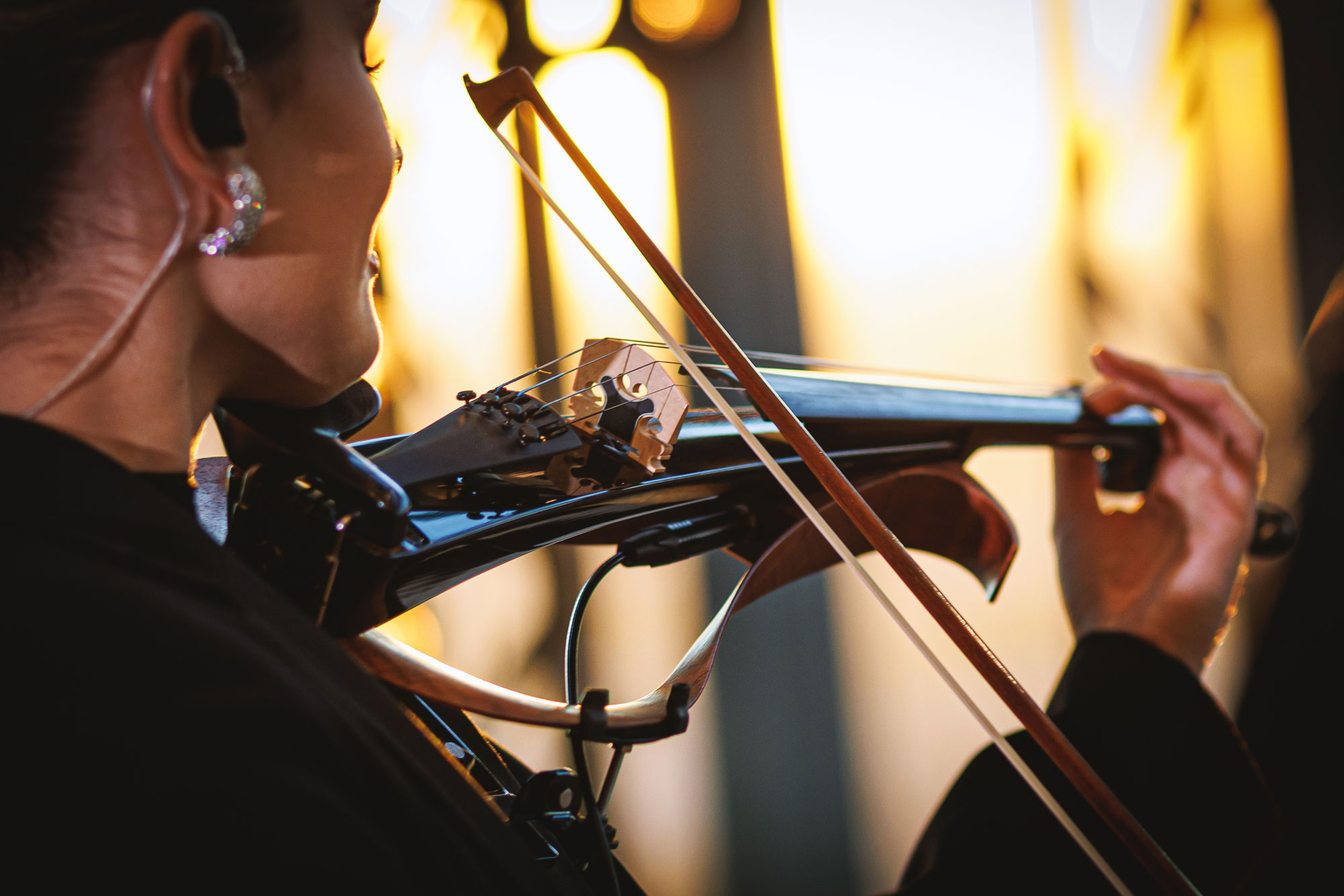 violinist performing with in ear monitor