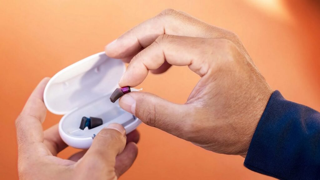 signia silk charge and go IX lifestyle aids in charger with hands