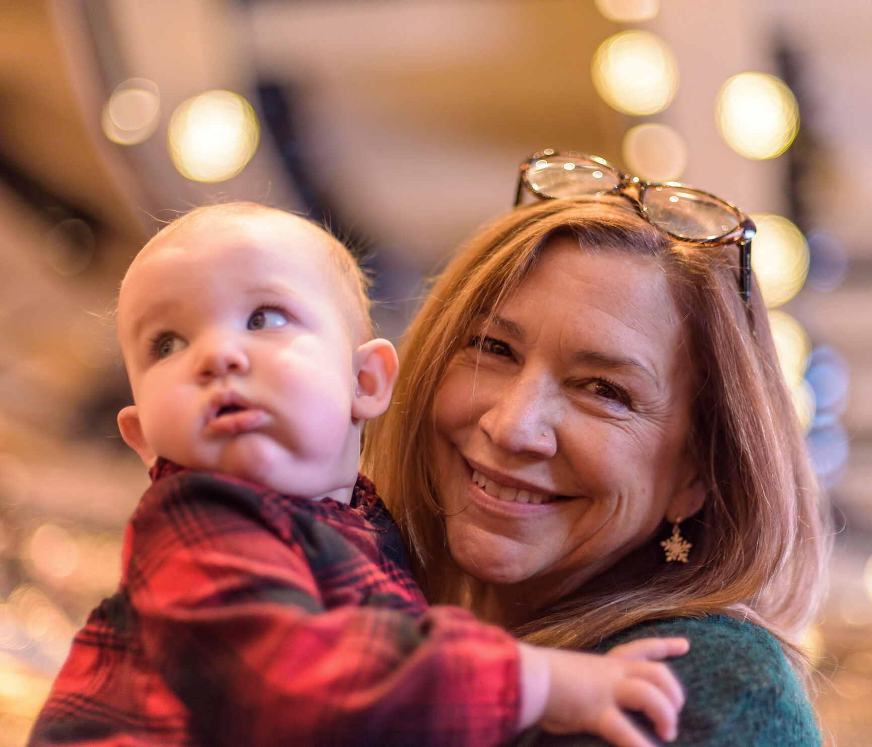 grandmother holding grandchild at holiday market