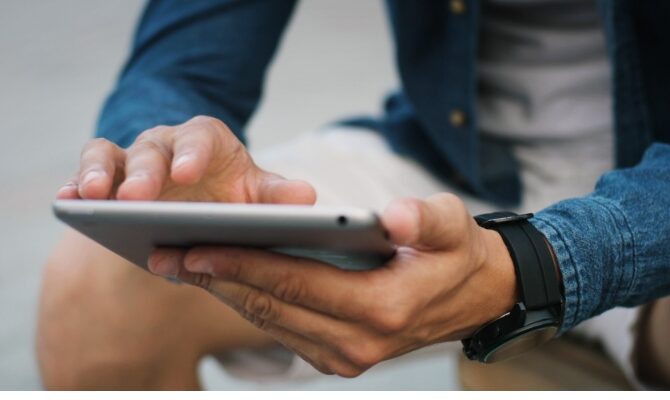 cta stacked senior using tablet back view closeup