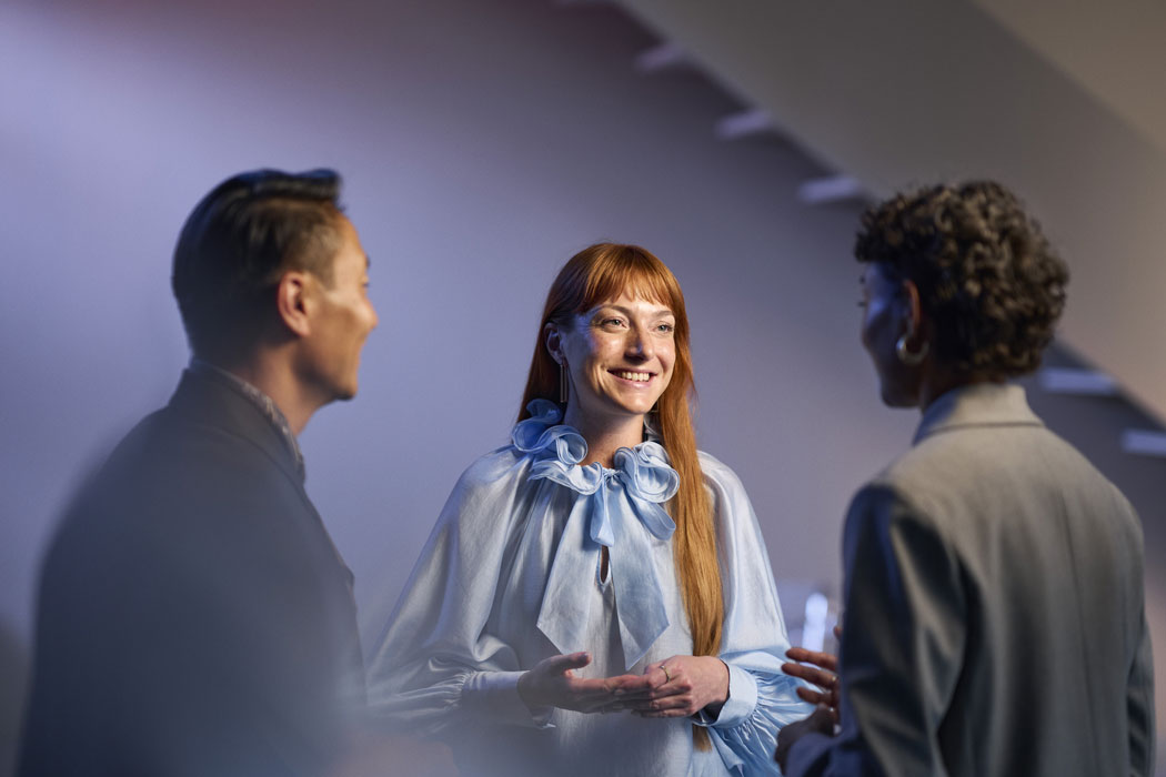 ReSound Vivia lifestyle hearing aid users talking in small group smiling