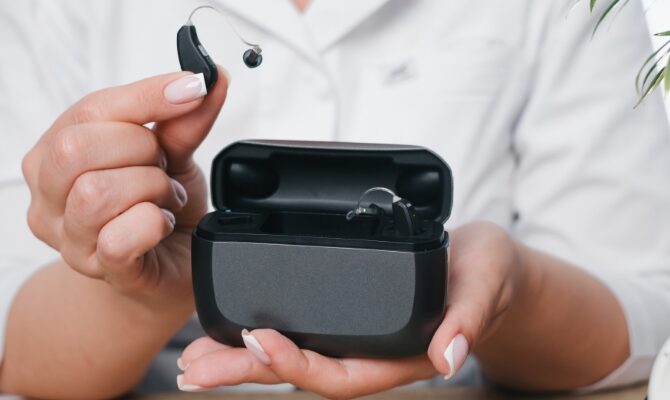 cta stacked prfoessional holding rechargable hearing aids