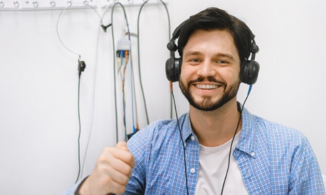 cta stacked man taking hearing test in booth