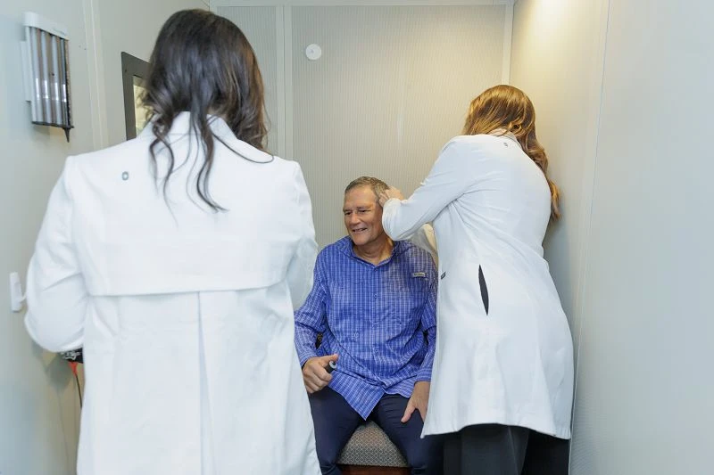 senior man during a comprehensive hearing assessment with the hearing center