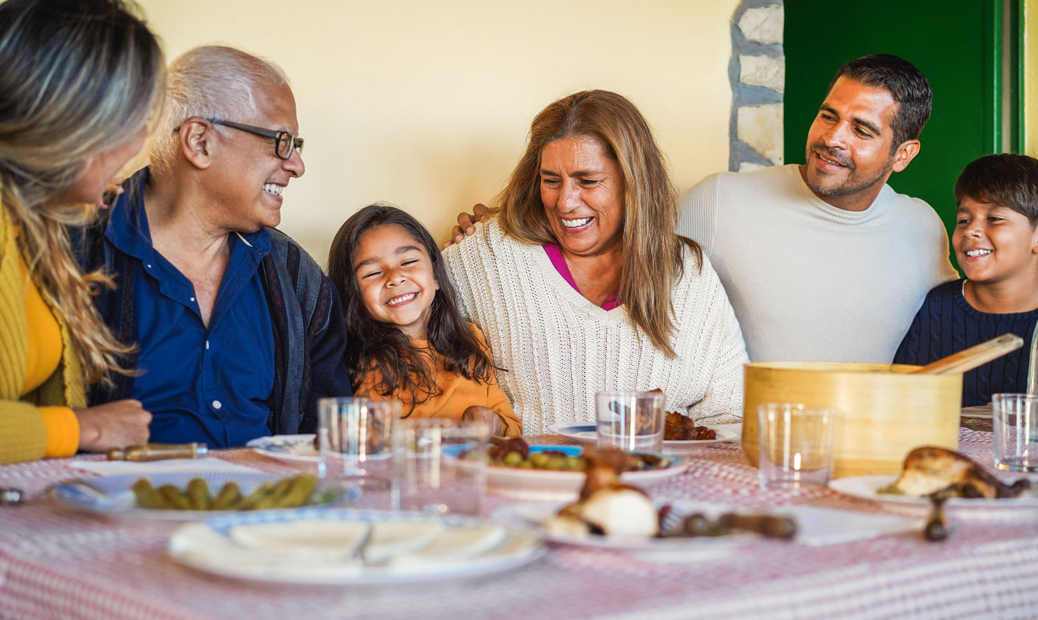 hispanic family smiling at dinner