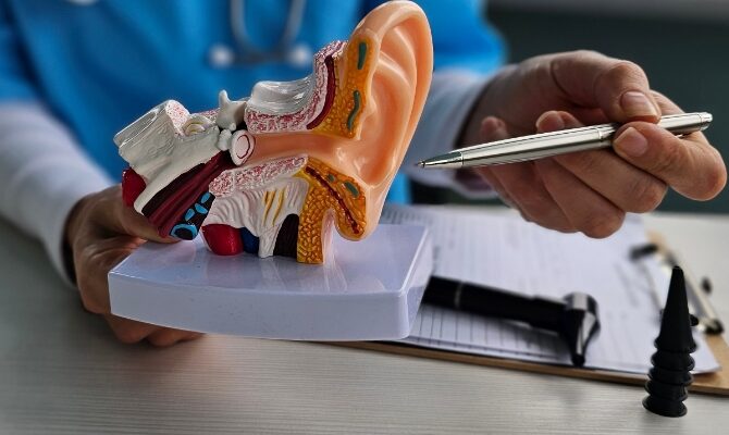 cta stacked audiologist pointing to ear model