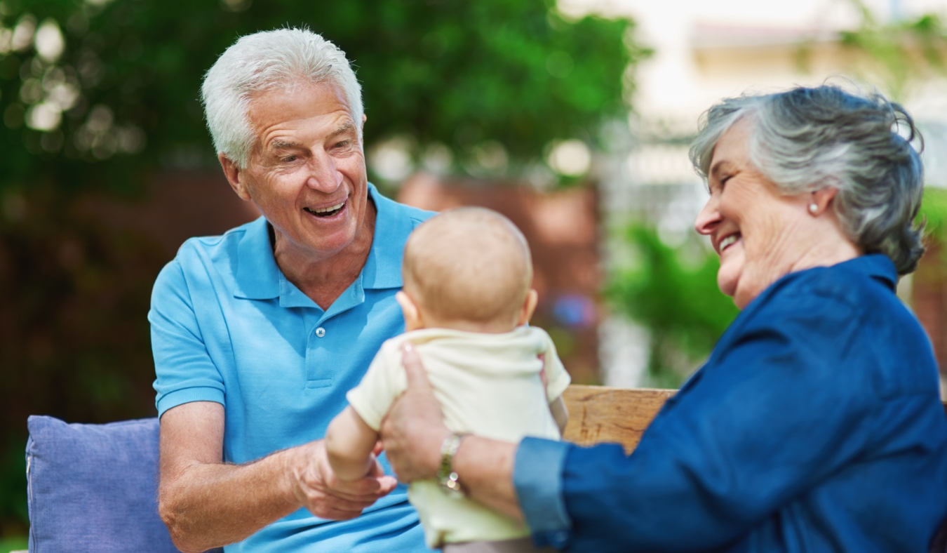 Park boy and grandfather with grandmother playful and bonding together