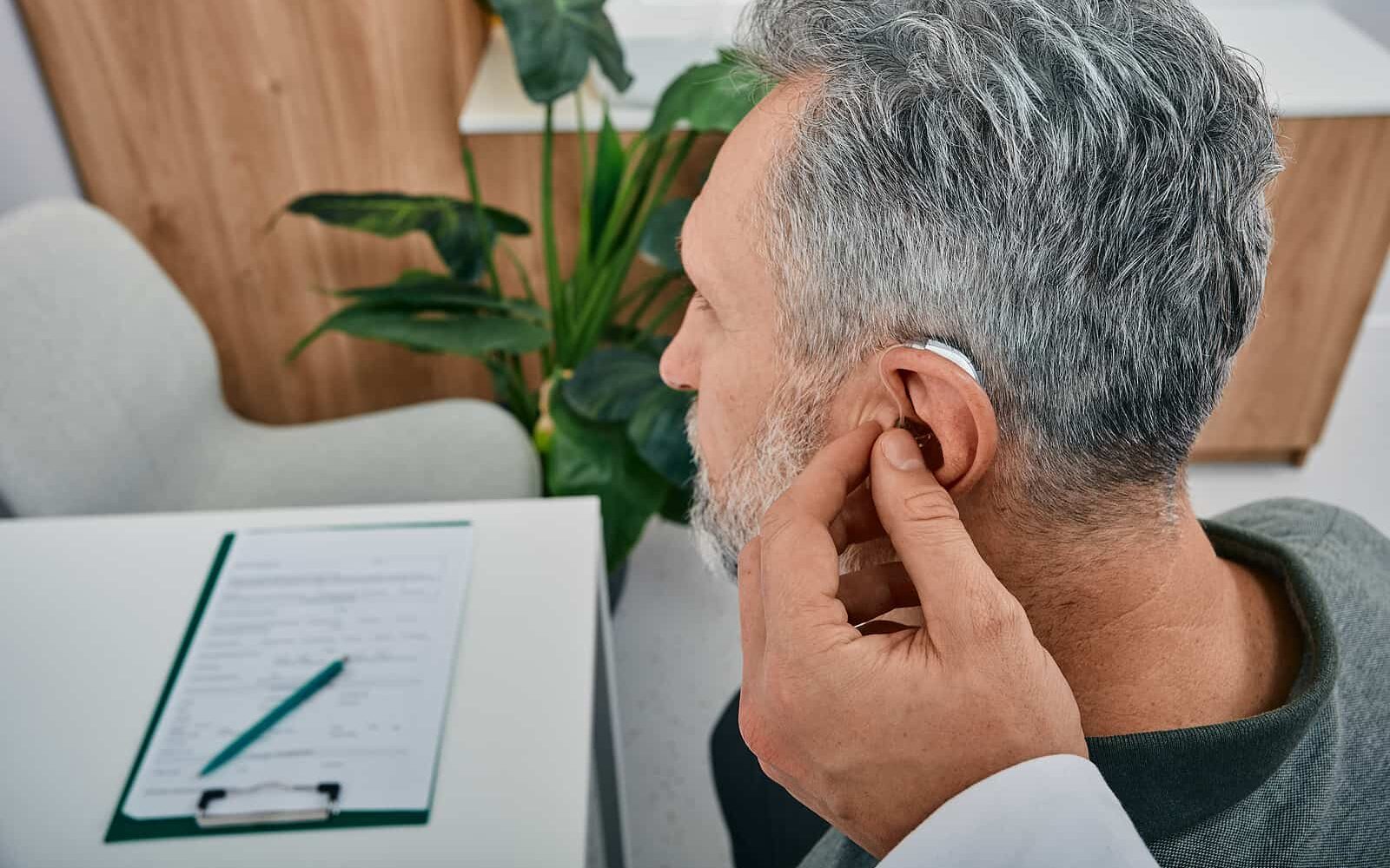 bigstock Audiologist Fits A Hearing Aid 446035826