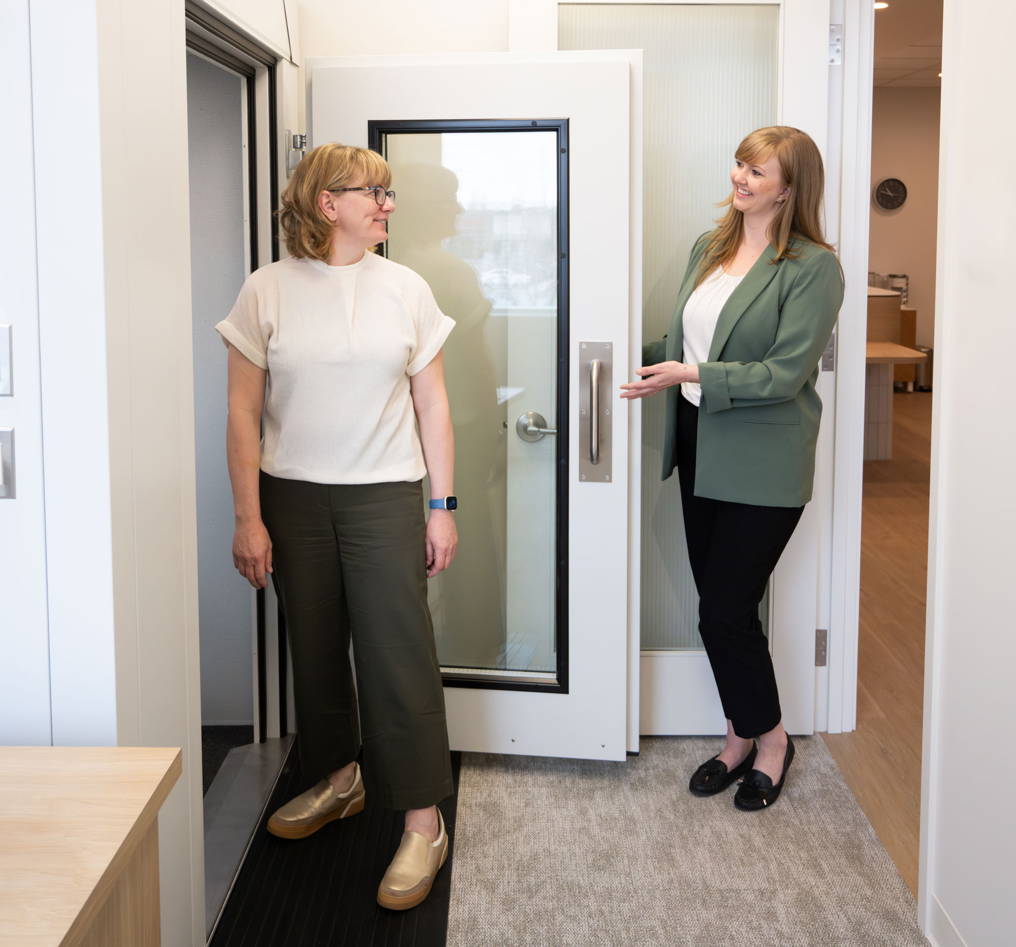 Veronica Gusikoski showing patinet sound booth for hearing test