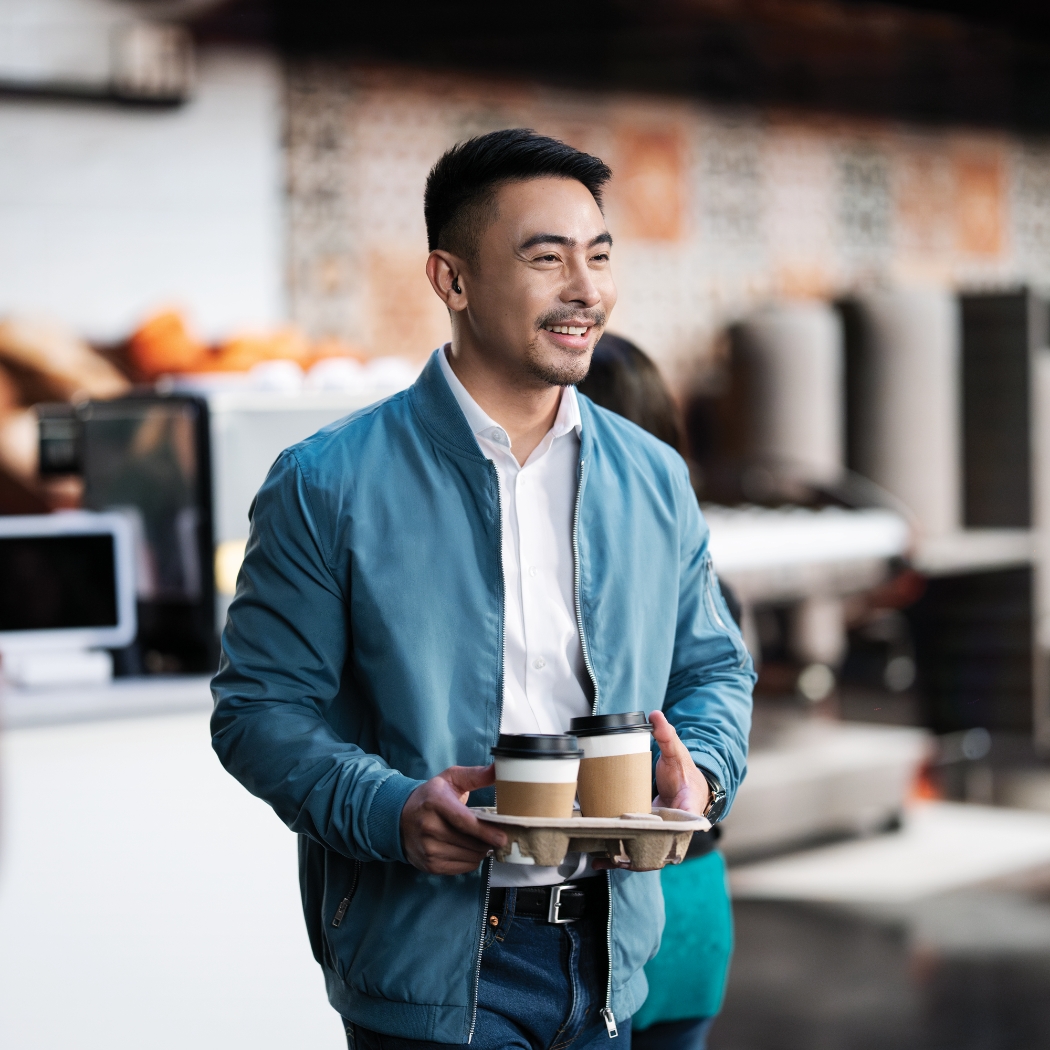 phonak virto i r lifestyle man holding coffee
