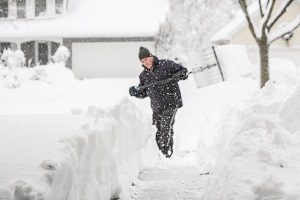 image of man shoveling snow in snowstorm