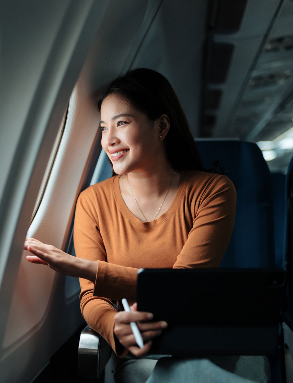 woman looking out airplane window