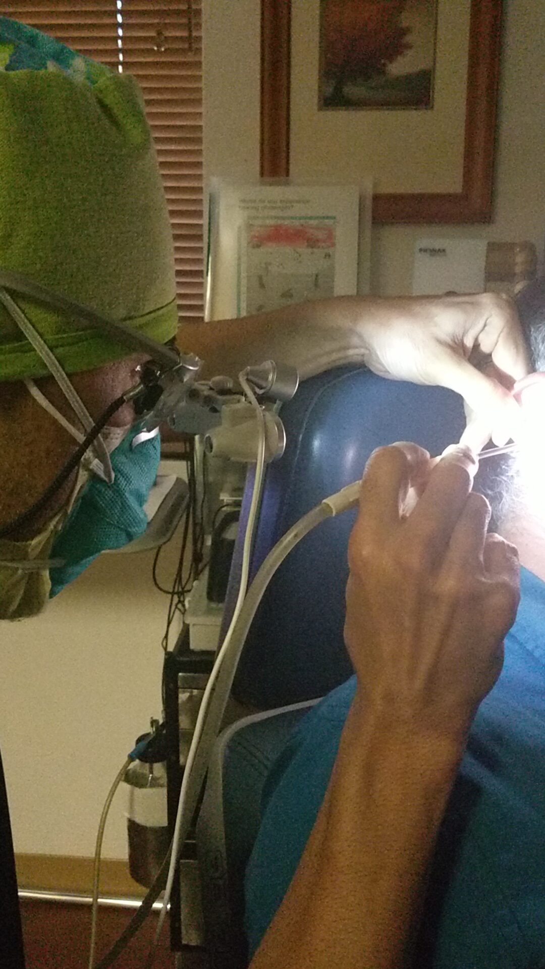 Andres Godinez Au D looking into patient ear