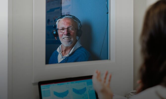 cta hover senior man hearing test in sound booth