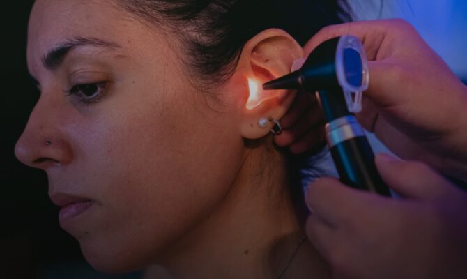cta hover audiologist using otoscope to examine womans ear