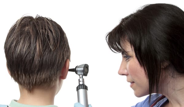 a pediatric ear doctor examining a childs ear