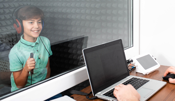 cta child taking hearing test in sound booth