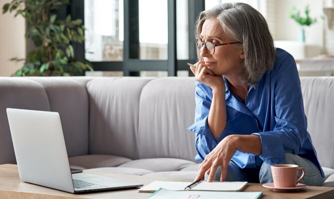 cta woman looking at laptop on couch