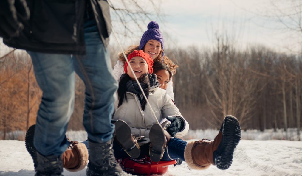 winter young women sledding