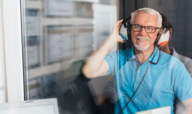 cta stacked old male taking hearing exam in sound booth