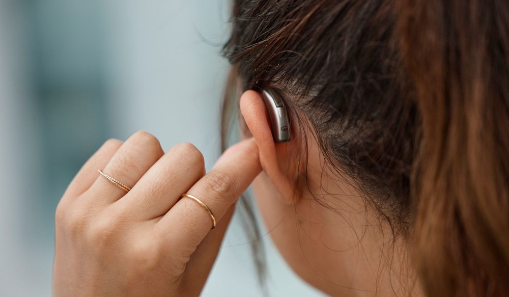 hearing aid on ear young woman