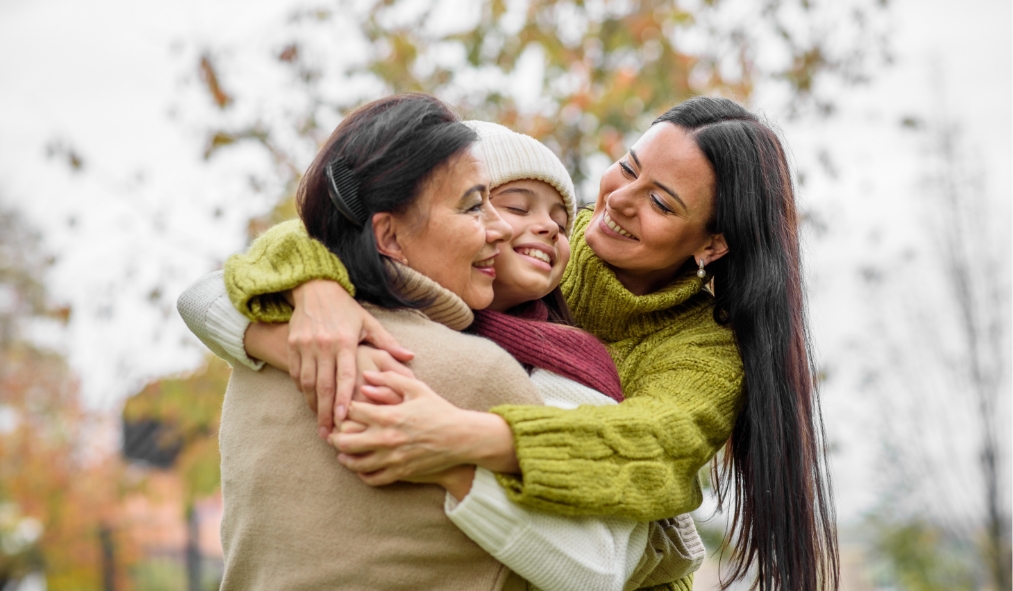 winter native three generations family hugging