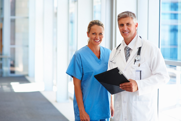 two doctors standing by a sunny window